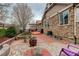 Backyard featuring a brick patio, fire pit, and stone accents, perfect for outdoor living at 21270 E Eldorado Dr, Aurora, CO 80013
