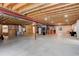 Unfinished basement providing an open canvas with exposed wood ceiling and concrete floor at 21270 E Eldorado Dr, Aurora, CO 80013