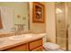 Bathroom featuring a neutral vanity, a framed mirror, and a glass-enclosed shower at 21270 E Eldorado Dr, Aurora, CO 80013
