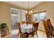 Cozy dining room with natural light, table for six, and sliding door access to outdoor patio at 21270 E Eldorado Dr, Aurora, CO 80013