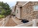 Exterior view of the house with a stone facade and a well-maintained yard with a white picket fence at 21270 E Eldorado Dr, Aurora, CO 80013
