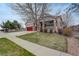 Beautiful home exterior with stone accents, red garage doors, and lovely landscaping at 21270 E Eldorado Dr, Aurora, CO 80013