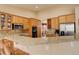 Bright kitchen with light wood cabinets, stainless steel refrigerator, and granite countertops at 21270 E Eldorado Dr, Aurora, CO 80013