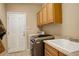 The laundry room includes wood cabinets, sink, washer, and dryer at 21270 E Eldorado Dr, Aurora, CO 80013
