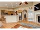 Open-concept living room with a fireplace, shelving, and an adjacent kitchen with granite countertops at 21270 E Eldorado Dr, Aurora, CO 80013