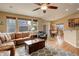 Spacious living room with a sofa, hardwood flooring, and adjacent dining area and kitchen at 21270 E Eldorado Dr, Aurora, CO 80013