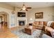 Comfortable living room featuring a stone fireplace, hardwood floors, and a leather sofa at 21270 E Eldorado Dr, Aurora, CO 80013