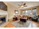 Inviting living room with a stone fireplace, large leather sofa, and hardwood floors at 21270 E Eldorado Dr, Aurora, CO 80013