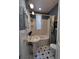 Quaint bathroom with a pedestal sink, patterned wallpaper, and shower-tub combo, exudes vintage charm at 231 W Ellsworth Ave, Denver, CO 80223