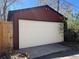 Spacious detached garage with a white door complementing the red exterior at 231 W Ellsworth Ave, Denver, CO 80223
