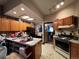 Kitchen features oak cabinets, a center island, a black refrigerator, and an older range at 231 W Ellsworth Ave, Denver, CO 80223