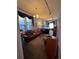 Bright living room with a brown leather couch, an aquarium, and large window at 231 W Ellsworth Ave, Denver, CO 80223