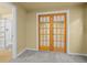 Basement view showing french doors, a bathroom with a glass enclosed shower, and neutral carpet at 9814 Norfolk St, Commerce City, CO 80022