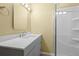 Bathroom featuring a gray vanity with solid surface counter and a glass enclosed shower at 9814 Norfolk St, Commerce City, CO 80022