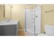 Bathroom with gray vanity and glass enclosed shower at 9814 Norfolk St, Commerce City, CO 80022