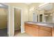Bathroom featuring dual sinks, spacious vanity, and well-lit mirror at 9814 Norfolk St, Commerce City, CO 80022
