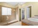 Bathroom featuring tiled glass shower with window and walk in closet at 9814 Norfolk St, Commerce City, CO 80022