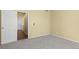 Bedroom featuring gray carpet, neutral paint and an open door at 9814 Norfolk St, Commerce City, CO 80022