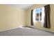 Bedroom featuring gray carpet, neutral paint, and window at 9814 Norfolk St, Commerce City, CO 80022