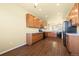 Spacious kitchen with wood cabinets, light countertops, modern appliances, and hardwood floors at 9814 Norfolk St, Commerce City, CO 80022