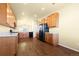 Open kitchen featuring wood cabinets, light countertops, modern appliances, and hardwood floors at 9814 Norfolk St, Commerce City, CO 80022