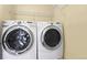 Washer and dryer with a wire shelf on the wall in a dedicated laundry space at 9814 Norfolk St, Commerce City, CO 80022