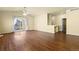 Open living room with a ceiling fan, access to a patio and hardwood floors at 9814 Norfolk St, Commerce City, CO 80022