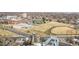 An aerial shot captures an area with an educational campus, football field, baseball field, and city buildings at 2899 N Speer Blvd # 203, Denver, CO 80211
