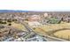 An aerial shot captures an area with an educational campus, football field, baseball field, and city buildings at 2899 N Speer Blvd # 203, Denver, CO 80211