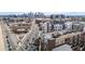 Aerial view of a modern apartment building with a city skyline and green spaces at 2899 N Speer Blvd # 203, Denver, CO 80211
