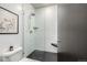 Bright bathroom featuring a shower with white subway tiles, black floor tiles and minimalist design at 2899 N Speer Blvd # 203, Denver, CO 80211
