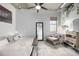 Well-lit bedroom featuring modern décor, industrial ceiling, and a cozy armchair with lots of natural light at 2899 N Speer Blvd # 203, Denver, CO 80211