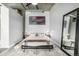 Bedroom featuring modern decor, industrial-style ceiling, and a stylish area rug, with a large mirror at 2899 N Speer Blvd # 203, Denver, CO 80211