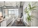 Contemporary dining area with modern lighting, table for six, and industrial ceiling details at 2899 N Speer Blvd # 203, Denver, CO 80211