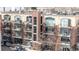 Brick building with balconies and patios, and storefronts on the ground level at 2899 N Speer Blvd # 203, Denver, CO 80211