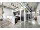 Modern kitchen with sleek black cabinetry, a white breakfast bar, and stainless steel appliances at 2899 N Speer Blvd # 203, Denver, CO 80211