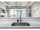 Kitchen with stainless steel sink, white countertops and subway tile, with an industrial-style ceiling at 2899 N Speer Blvd # 203, Denver, CO 80211