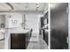 Modern kitchen with stainless steel appliances, sleek cabinetry, and an island with a white countertop at 2899 N Speer Blvd # 203, Denver, CO 80211