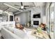 Bright and open living room featuring a cozy fireplace and modern, industrial-style design at 2899 N Speer Blvd # 203, Denver, CO 80211