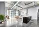 Open living space with large windows, modern kitchen, industrial ceiling, and stylish decor at 2899 N Speer Blvd # 203, Denver, CO 80211