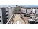 Inviting rooftop patio with stone tile, tables, chairs, grill, and great views for residents at 2899 N Speer Blvd # 203, Denver, CO 80211