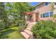 Beautiful backyard featuring a deck, lush lawn, mature trees, and landscaping, offering a private retreat at 10089 Wynwood Way, Highlands Ranch, CO 80126