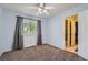 Bright bedroom with plush carpet, ample lighting, and a window offering exterior views at 10089 Wynwood Way, Highlands Ranch, CO 80126