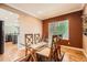 Cozy dining room featuring a glass-top table with seating for four and a window overlooking the backyard at 10089 Wynwood Way, Highlands Ranch, CO 80126