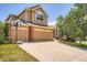 Charming home featuring a two-car garage and a well-manicured front yard at 10089 Wynwood Way, Highlands Ranch, CO 80126