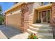 Inviting front porch with elegant brick accents and a well-maintained walkway at 10089 Wynwood Way, Highlands Ranch, CO 80126