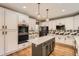 Modern kitchen with white cabinets, stainless appliances, and a stylish island at 10089 Wynwood Way, Highlands Ranch, CO 80126