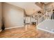 Bright living room with vaulted ceiling, hardwood floors, staircase and an entry door offering a welcoming atmosphere at 10089 Wynwood Way, Highlands Ranch, CO 80126