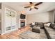 Cozy living room with a fireplace, built-in shelving, and comfortable seating at 10089 Wynwood Way, Highlands Ranch, CO 80126