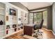 Inviting home office featuring custom built-in bookshelves, bay windows, and a comfortable workspace perfect for productivity at 10089 Wynwood Way, Highlands Ranch, CO 80126